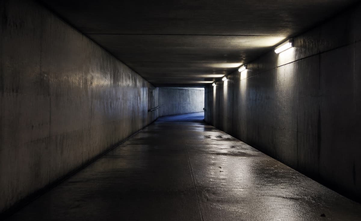 Narrow underground passage with weak light
