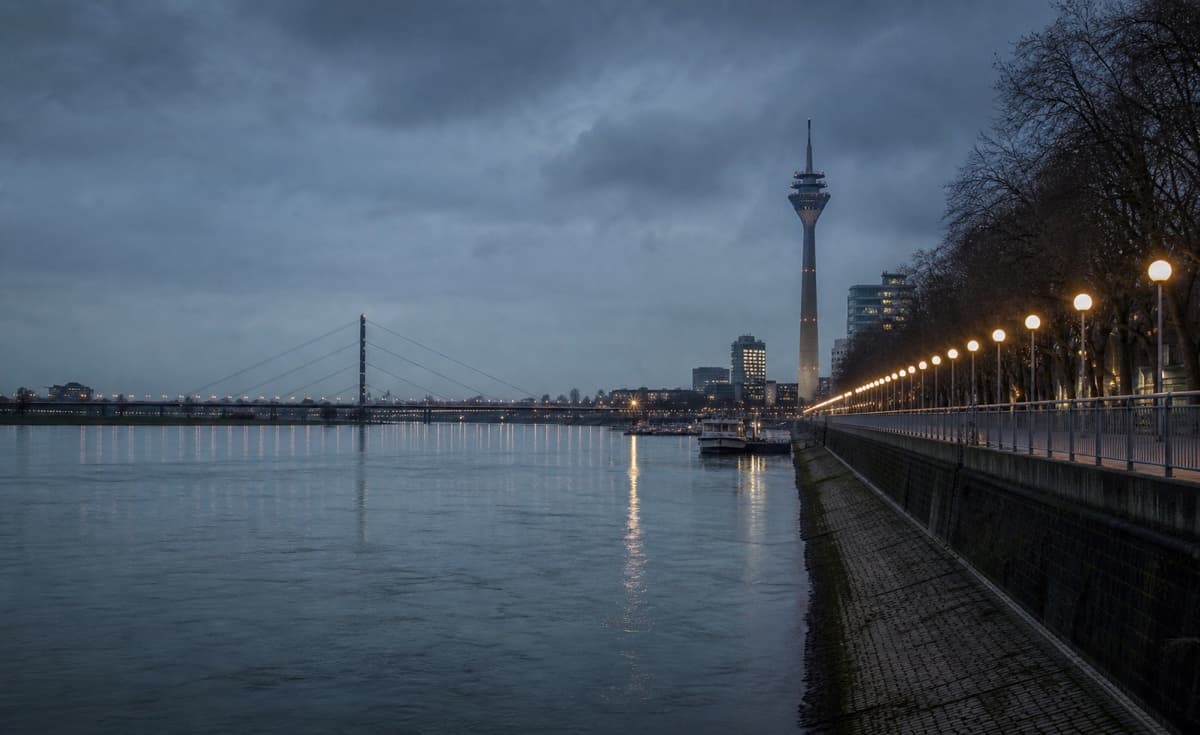 Riverbank at night with restrained light reflections